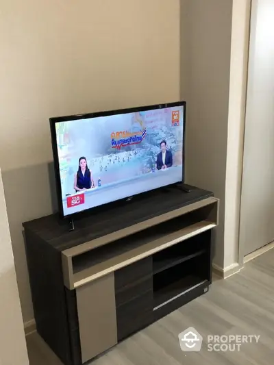 Modern living room with sleek TV stand and flat-screen television