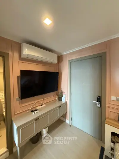 Modern living room with wall-mounted TV and air conditioning unit