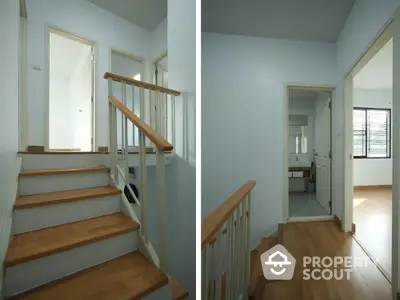 Spacious hallway with wooden stairs and natural light in modern home