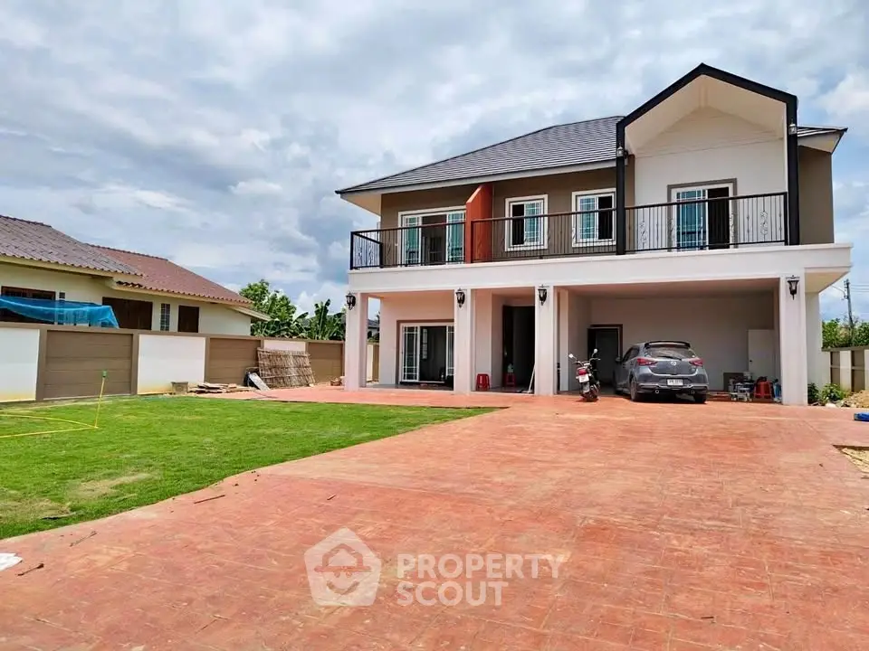 Spacious two-story house with large driveway and lush green lawn