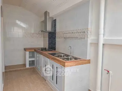 Modern kitchen with sleek countertops and gas stove in a bright, airy space.