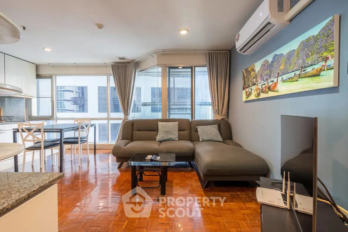 Spacious living room with modern decor and large windows in a stylish apartment.