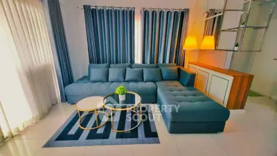 Modern living room with stylish blue sectional sofa and elegant decor