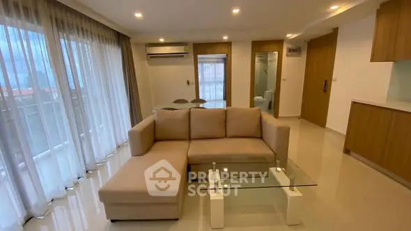 Spacious modern living room with large windows and elegant furniture