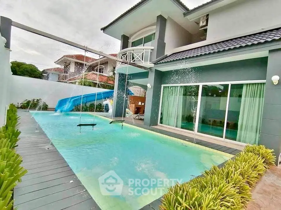 Luxurious modern home with private pool and water features, perfect for family entertainment.