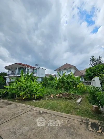 Charming suburban homes with lush greenery and cloudy sky