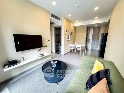 Modern living room with stylish decor, wall-mounted TV, and cozy seating area.