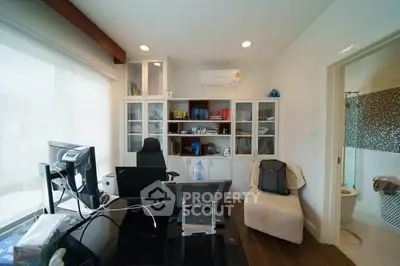 Modern home office with sleek desk, ergonomic chair, and ample storage in a bright, airy room.