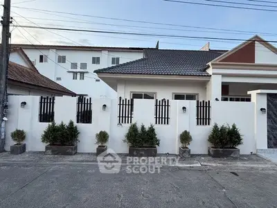 Charming suburban house with modern facade and potted plants