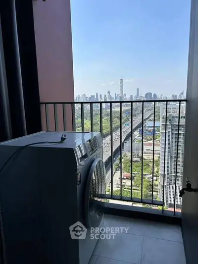 High-rise balcony with washing machine and stunning city skyline view