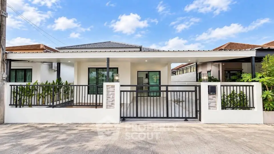 Charming single-story home with modern facade and lush greenery, perfect for family living.