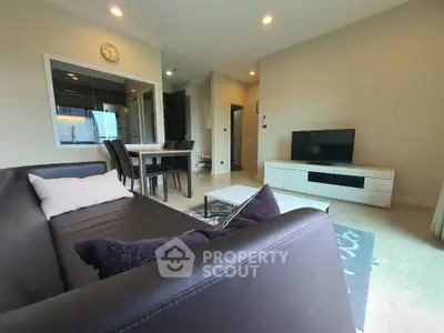 Modern living room with sleek furniture and open dining area, perfect for contemporary living.