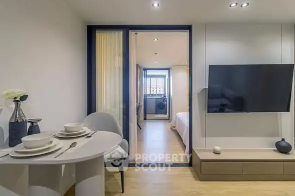 Modern apartment interior with open living space and bedroom view