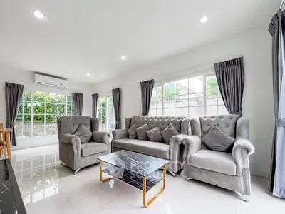 Spacious modern living room with elegant gray furniture and large windows