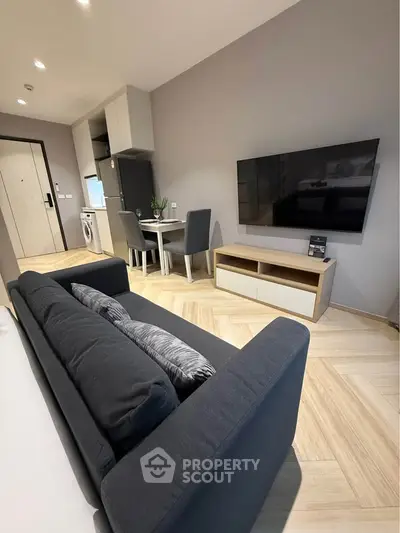 Modern living room with sleek furniture and open layout in a stylish apartment.