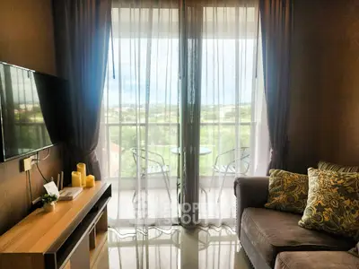 Cozy living room with balcony view, modern decor, and natural light.