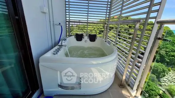 Luxurious balcony with private jacuzzi and stunning green view, perfect for relaxation and leisure.