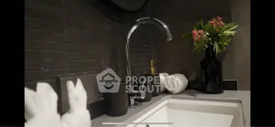 Modern bathroom sink with stylish faucet and decorative elements