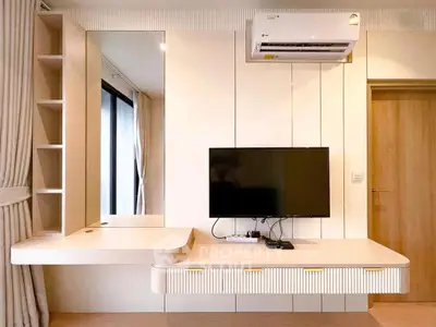 Modern living room with sleek TV setup and air conditioning