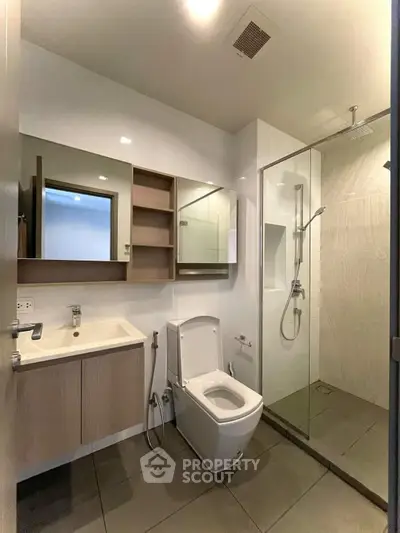 Modern bathroom with sleek fixtures and glass shower enclosure