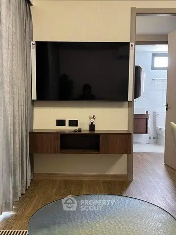 Modern living room with wall-mounted TV and wooden cabinet