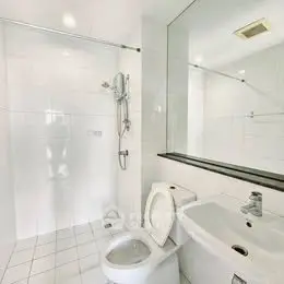 Modern bathroom with sleek white tiles and contemporary fixtures