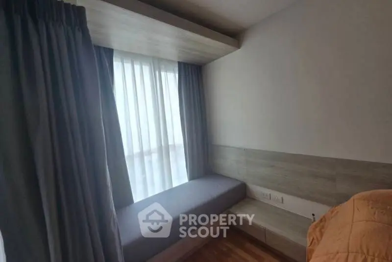 Cozy bedroom with built-in window seat and modern design.