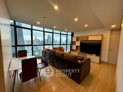 Spacious living room with stunning city view and modern furnishings
