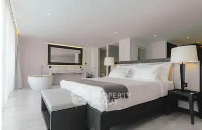 Luxurious modern bedroom with elegant decor and freestanding bathtub