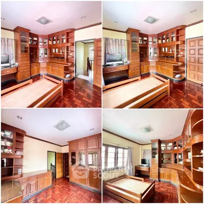 Spacious bedroom with elegant wooden cabinetry and parquet flooring, featuring ample natural light and classic design.