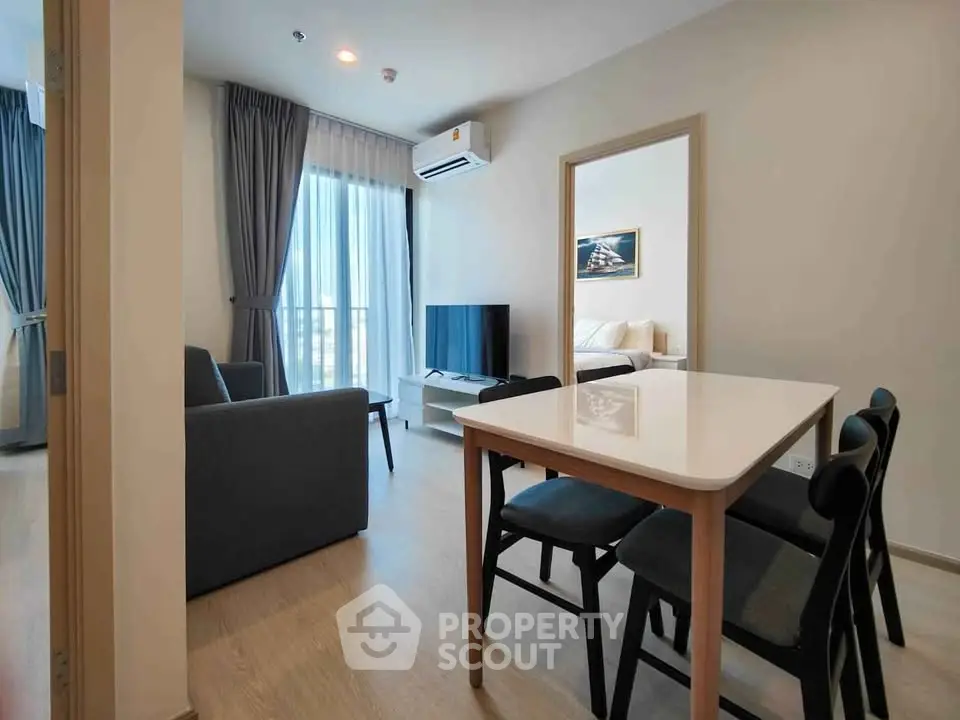 Modern living room with dining area and natural light in stylish apartment