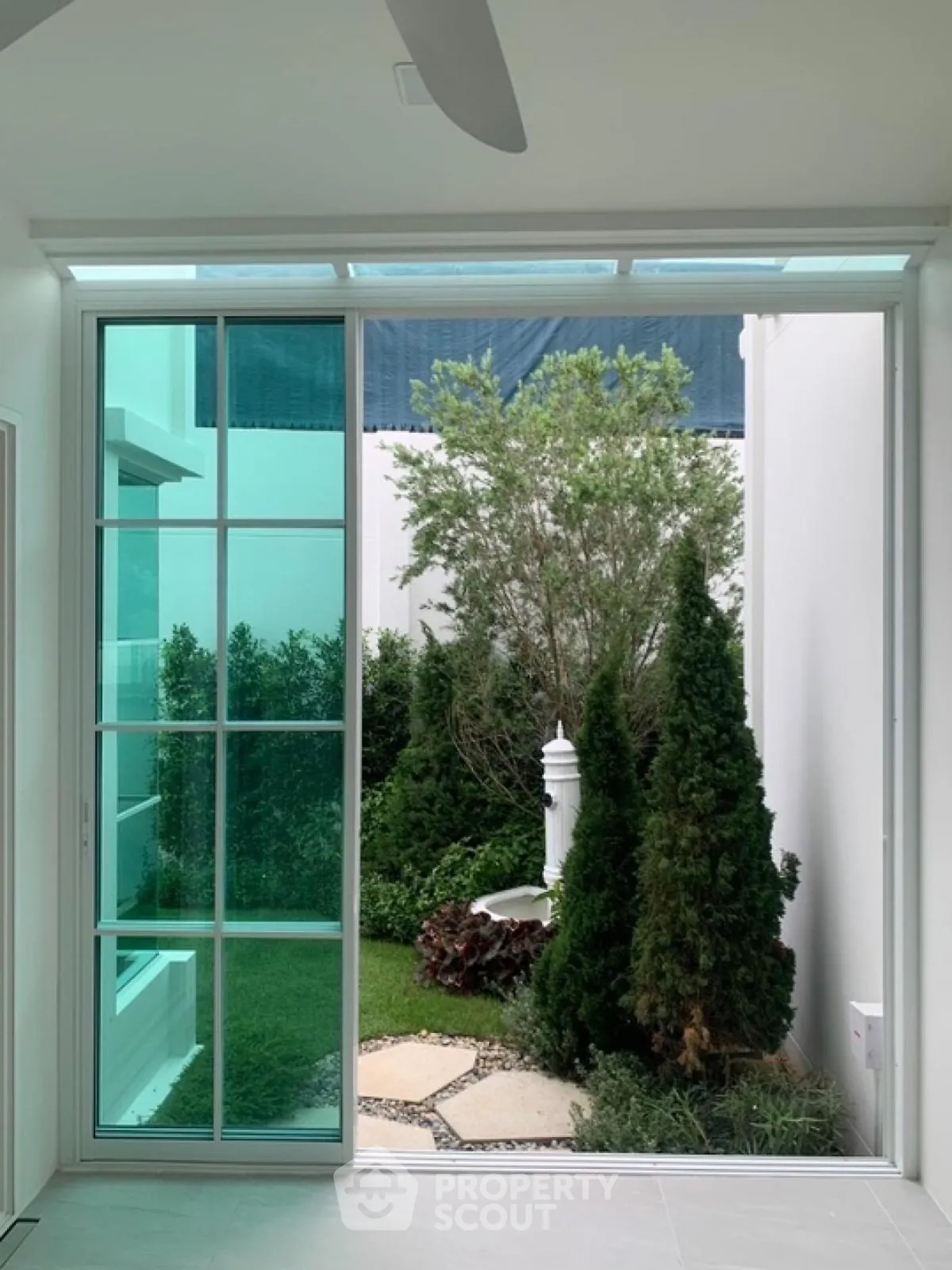Charming garden view through modern glass doors in a stylish home