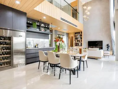 Luxurious open-plan living and dining area with high ceilings and modern decor