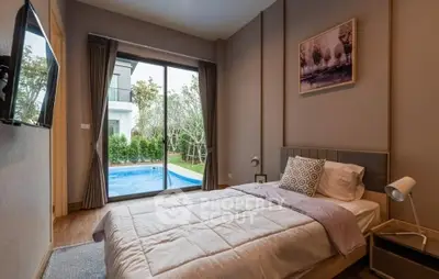 Cozy bedroom with pool view, modern decor, and natural light.