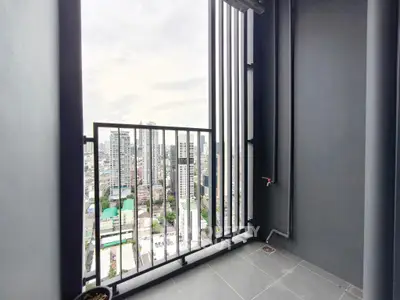 Modern high-rise balcony with stunning cityscape view, perfect for urban living enthusiasts.