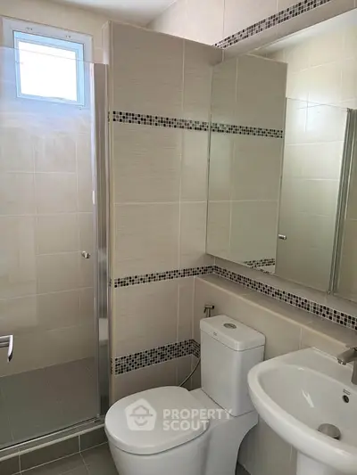 Modern bathroom with sleek fixtures and glass shower enclosure