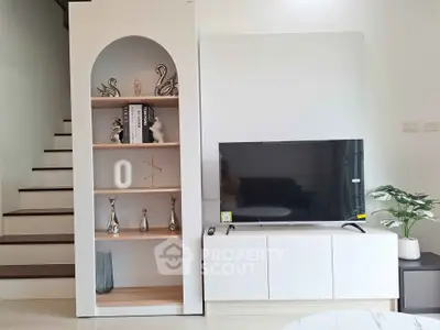 Modern living room with stylish TV unit and decorative shelving, perfect for contemporary homes.