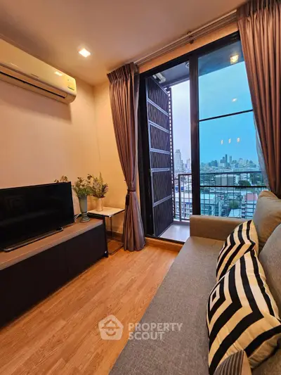 Modern living room with balcony and city view, featuring stylish decor and natural light.