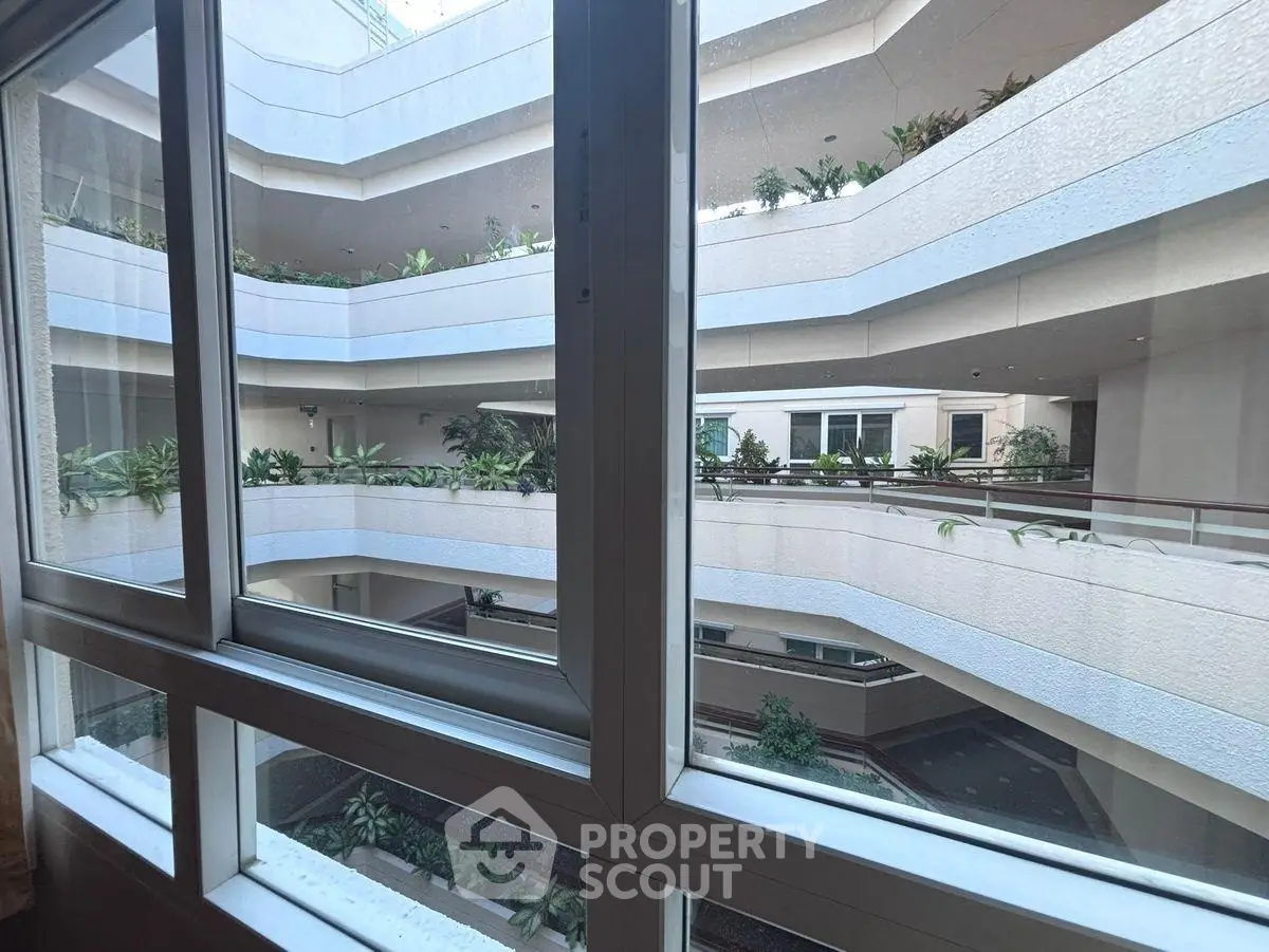 Modern building interior with multiple levels and lush greenery