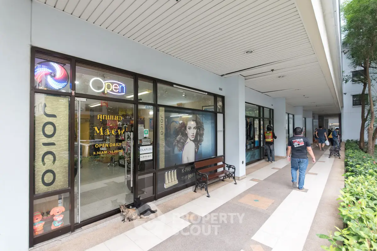 Commercial property exterior with glass storefronts and walkway, ideal for retail business.