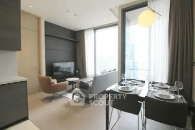 Modern living room with dining area and balcony view in a stylish apartment.