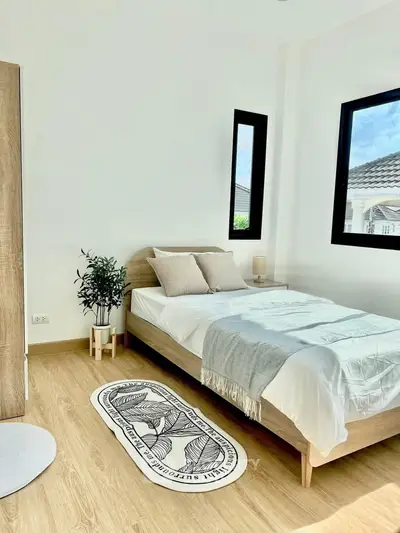 Bright and airy bedroom with modern decor and large windows