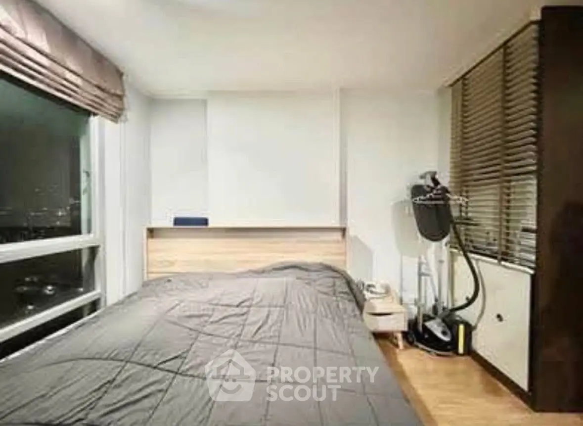 Modern bedroom with large window and sleek design in urban apartment