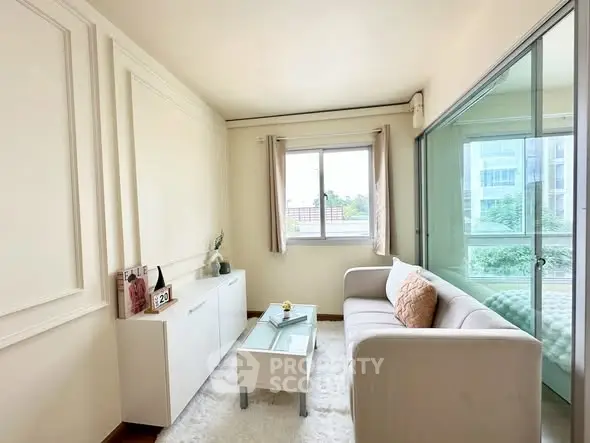 Bright and cozy living room with modern decor and large window view.