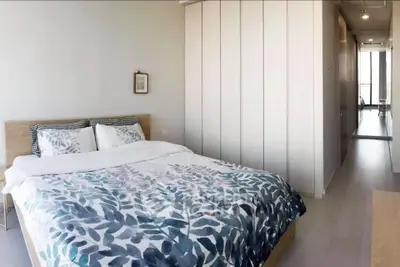 Spacious bedroom with modern decor and ample natural light