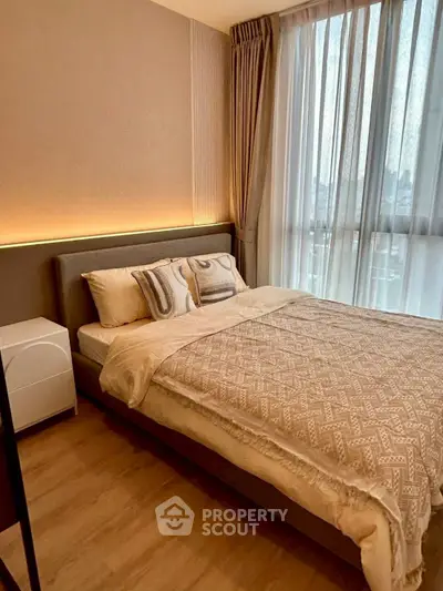 Cozy modern bedroom with stylish decor and large window view