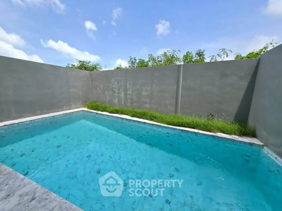 Luxurious private pool with serene surroundings and clear blue water, perfect for relaxation and leisure.