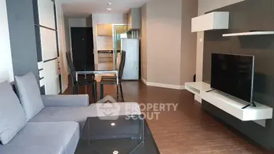 Modern living room with sleek furniture and open kitchen layout