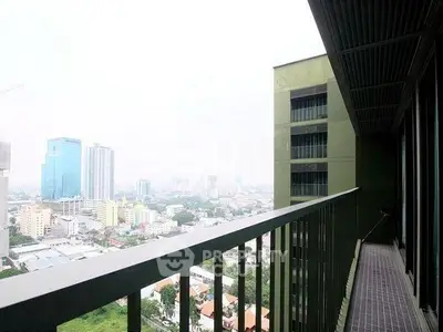 Spacious balcony with stunning city view in modern high-rise building.