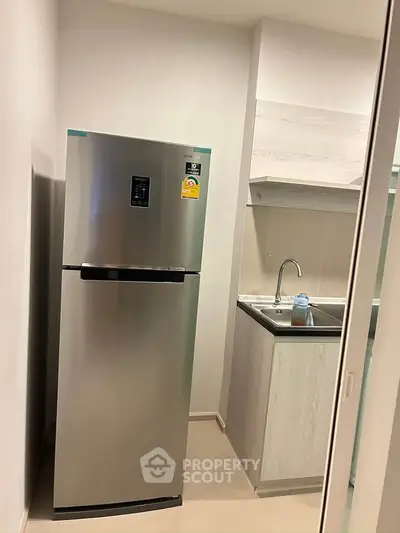 Modern kitchen with stainless steel fridge and sleek cabinetry